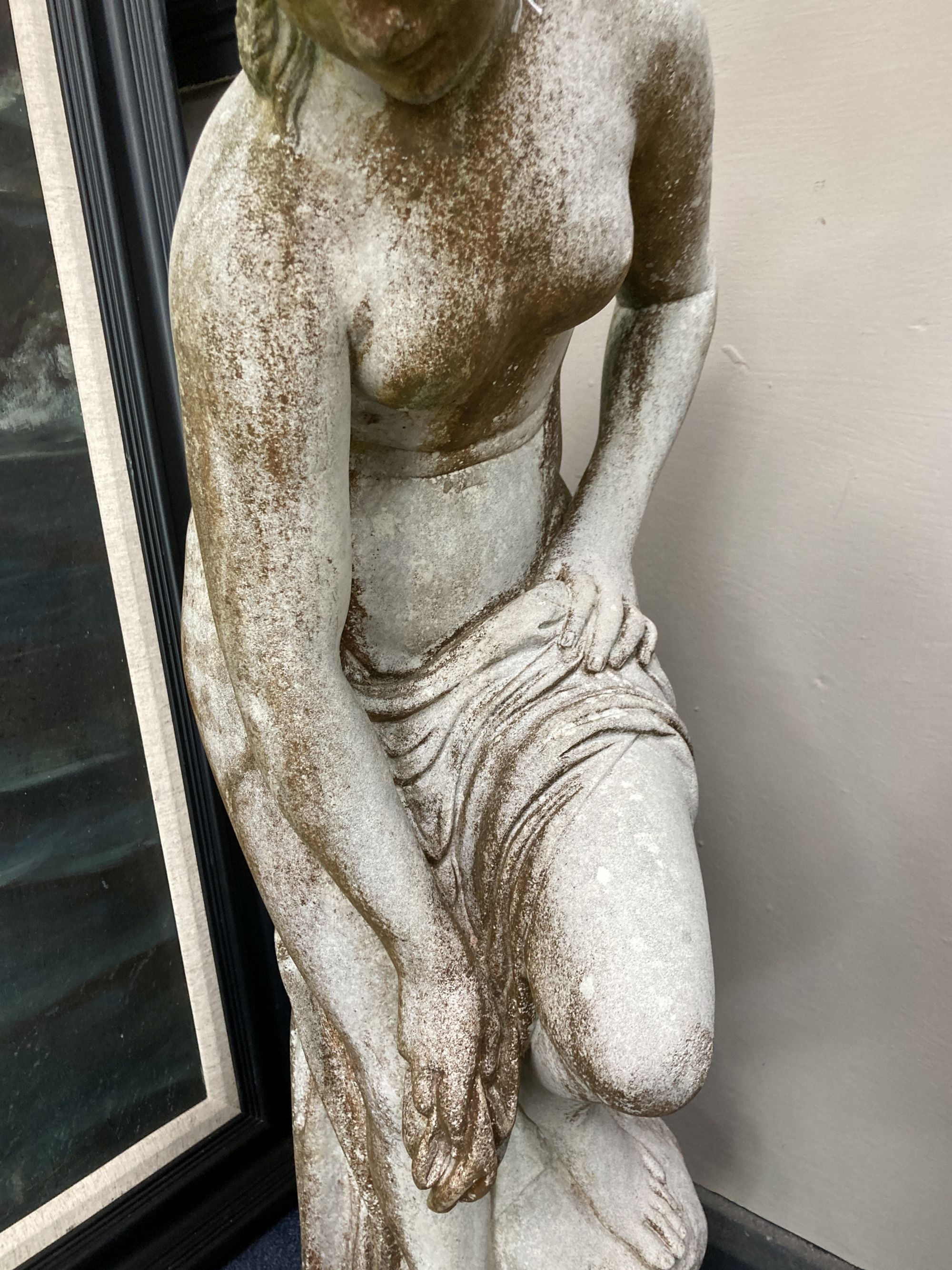 A reconstituted stone garden ornament of a female bather, 86cm high